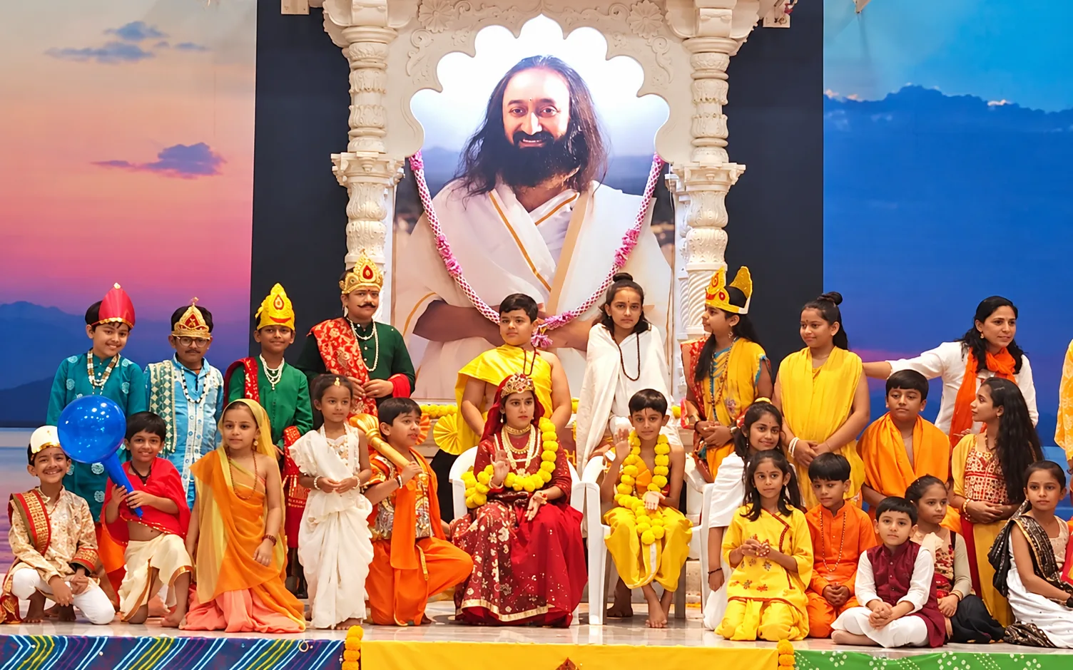 Children in costume on stage at a Sri Sri Sanskar Kendra celebration